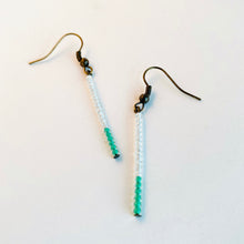 Load image into Gallery viewer, Elegant, minimalist earrings of white and turquoise seed beads dangle in a single strand from brass ear wires.  Size: 2 inch drop length
