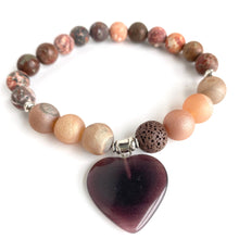 Load image into Gallery viewer, Rusts, Browns, Creams, and Champagne meld into a stunning diffuser bracelet with a  brown glass heart charm. Silver Spacer Beads. Apply 1-2 drops of your favorite essential oil on the brown lava stone - breathe deep and fill your heart with gratitude.  Type: Diffuser Bracelet Size: 7 Beads: 8 mm Leopard Jasper, 10 mm Amber Agate, 10 mm lava stone
