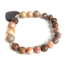 Load image into Gallery viewer, Rusts, Browns, Creams, and Champagne meld into a stunning diffuser bracelet with a  brown glass heart charm. Silver Spacer Beads. Apply 1-2 drops of your favorite essential oil on the brown lava stone - breathe deep and fill your heart with gratitude.  Type: Diffuser Bracelet Size: 7 Beads: 8 mm Leopard Jasper, 10 mm Amber Agate, 10 mm lava stone
