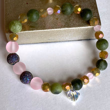 Load image into Gallery viewer, Diffuser bracelet that sparkles with its Swarovski charm and iridescent lava beads to diffuse your favorite scent. Combined with Yellow Howlite (which is really shades of green) and pink glass beads, make this your wow! bracelet.  Type: Diffuser Stretch Bracelet Size: 6 1/2 Bead Sizes: 4mm, 8mm
